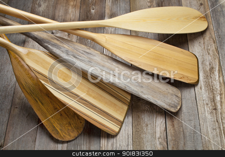 To use this stock image in your creative project, please select the size you need over to the right and click the "Add to Cart" button.
Your downloaded image will come with the Cutcaster watermark removed so don’t worry about the watermark you see on this page. wooden canoe paddles stock photo, pile of wooden canoe paddles with different shapes and sizes of blades against grained wood deck by Marek Uliasz