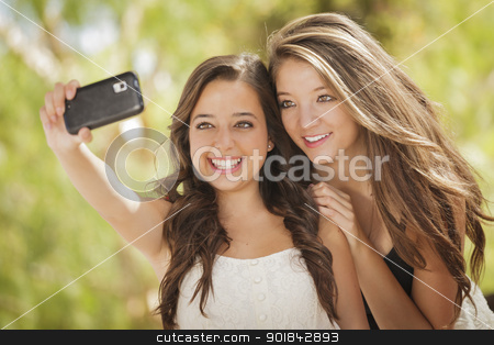 To use this stock image in your creative project, please select the size you need over to the right and click the "Add to Cart" button.
Your downloaded image will come with the Cutcaster watermark removed so don’t worry about the watermark you see on this page. Attractive Mixed Race Girlfriends Taking Self Portrait with Came stock photo, Two Attractive Mixed Race Girlfriends Taking Self Portrait with Their Phone Camera Outdoors. by Andy Dean