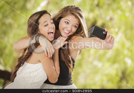To use this stock image in your creative project, please select the size you need over to the right and click the "Add to Cart" button.
Your downloaded image will come with the Cutcaster watermark removed so don’t worry about the watermark you see on this page. Attractive Mixed Race Girlfriends Taking Self Portrait with Came stock photo, Two Attractive Mixed Race Girlfriends Taking Self Portrait with Their Phone Camera Outdoors. by Andy Dean