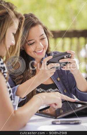To use this stock image in your creative project, please select the size you need over to the right and click the "Add to Cart" button.
Your downloaded image will come with the Cutcaster watermark removed so don’t worry about the watermark you see on this page. Mixed Race Girls Working on Electronic Devices stock photo, Attractive Mixed Race Girls Smiling and Talking While Working on Smart Mobile Phone and Tablet Computer. by Andy Dean