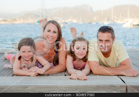 To use this stock image in your creative project, please select the size you need over to the right and click the "Add to Cart" button.
Your downloaded image will come with the Cutcaster watermark removed so don’t worry about the watermark you see on this page. summer family stock photo, summer family smiling laying on beach. by mandygodbehear