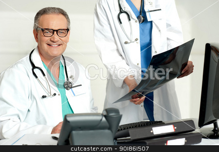 To use this stock image in your creative project, please select the size you need over to the right and click the "Add to Cart" button.
Your downloaded image will come with the Cutcaster watermark removed so don’t worry about the watermark you see on this page. Woman assistant presenting x-ray report to male doctor stock photo, Woman assistant presenting x-ray report to male doctor. Indoor shot by Ishay Botbol