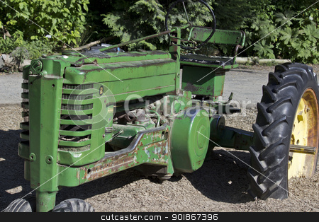 To use this stock image in your creative project, please select the size you need over to the right and click the "Add to Cart" button.
Your downloaded image will come with the Cutcaster watermark removed so don’t worry about the watermark you see on this page. Vintage Tractor 2 stock photo, A vintage green tractor with a large yellow wheel by Jadthree