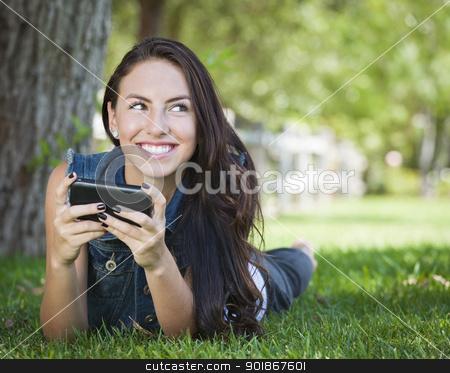 To use this stock image in your creative project, please select the size you need over to the right and click the "Add to Cart" button.
Your downloaded image will come with the Cutcaster watermark removed so don’t worry about the watermark you see on this page. Mixed Race Young Female Texting on Cell Phone Outside stock photo, Attractive Happy Mixed Race Young Female Texting on Her Cell Phone Outside Laying in the Grass. by Andy Dean