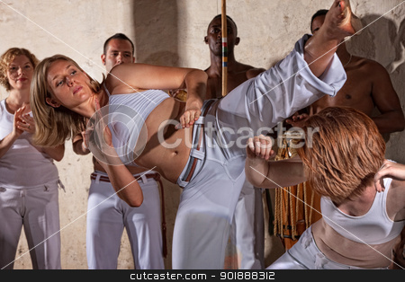 To use this stock image in your creative project, please select the size you need over to the right and click the "Add to Cart" button.
Your downloaded image will come with the Cutcaster watermark removed so don’t worry about the watermark you see on this page. Two Capoeria Fighters Practicing stock photo, Female Capoeria fighters practing with team indoors by Scott Griessel