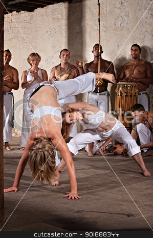 To use this stock image in your creative project, please select the size you need over to the right and click the "Add to Cart" button.
Your downloaded image will come with the Cutcaster watermark removed so don’t worry about the watermark you see on this page. Female Capoeria Performers stock photo, Pair of female capoeira practitioners performing with group by Scott Griessel