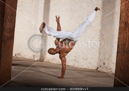 To use this stock image in your creative project, please select the size you need over to the right and click the "Add to Cart" button.
Your downloaded image will come with the Cutcaster watermark removed so don’t worry about the watermark you see on this page. Attractive Man Kicking stock photo, Attractive Brazilian man performing a capoeria kick by Scott Griessel