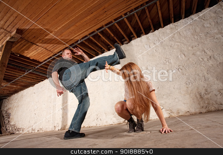 To use this stock image in your creative project, please select the size you need over to the right and click the "Add to Cart" button.
Your downloaded image will come with the Cutcaster watermark removed so don’t worry about the watermark you see on this page. Man Kicks Young Woman stock photo, Young woman being kicked by Caucasian male by Scott Griessel