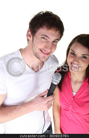 To use this stock image in your creative project, please select the size you need over to the right and click the "Add to Cart" button.
Your downloaded image will come with the Cutcaster watermark removed so don’t worry about the watermark you see on this page. Couple sharing a microphone stock photo, Couple sharing a microphone by photography33
