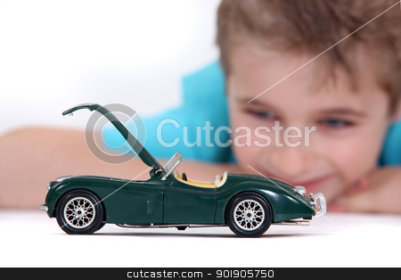 To use this stock image in your creative project, please select the size you need over to the right and click the "Add to Cart" button.
Your downloaded image will come with the Cutcaster watermark removed so don’t worry about the watermark you see on this page. Little boy watching a toy car stock photo, Little boy watching a toy car by photography33