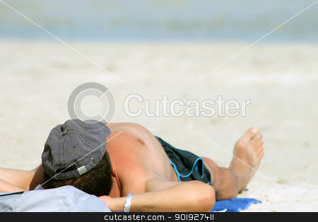 To use this stock image in your creative project, please select the size you need over to the right and click the "Add to Cart" button.
Your downloaded image will come with the Cutcaster watermark removed so don’t worry about the watermark you see on this page. Man sunbathing on beach stock photo, Rear view of man sunbathing on sandy beach with sea in background. by Martin Crowdy