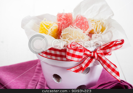 To use this stock image in your creative project, please select the size you need over to the right and click the "Add to Cart" button.
Your downloaded image will come with the Cutcaster watermark removed so don’t worry about the watermark you see on this page. coconut ice candy stock photo, Close up of white yellow and pink coconut ice confectionery with fresh coconuts isolated on white by p.studio66