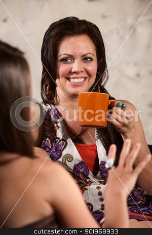 To use this stock image in your creative project, please select the size you need over to the right and click the "Add to Cart" button.
Your downloaded image will come with the Cutcaster watermark removed so don’t worry about the watermark you see on this page. Smiling Woman Drinking Coffee with Friend stock photo, Happy Caucasian brunette drinking coffee and talking with friend by Scott Griessel