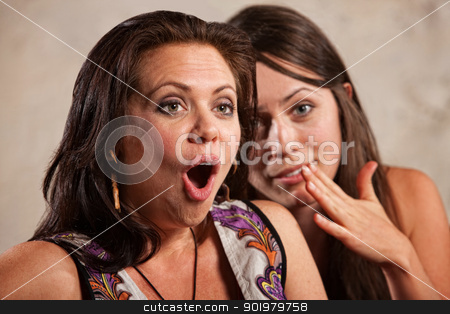 To use this stock image in your creative project, please select the size you need over to the right and click the "Add to Cart" button.
Your downloaded image will come with the Cutcaster watermark removed so don’t worry about the watermark you see on this page. Shocked Woman and Whispering Friend stock photo, Shocked young woman listening to friend whispering in her ear by Scott Griessel