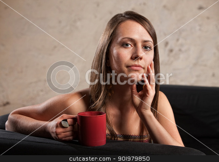 To use this stock image in your creative project, please select the size you need over to the right and click the "Add to Cart" button.
Your downloaded image will come with the Cutcaster watermark removed so don’t worry about the watermark you see on this page. Thoughtful Lady with Cup stock photo, Thoughtful Caucasian brunette female sitting with mug on sofa by Scott Griessel