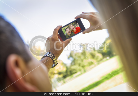 To use this stock image in your creative project, please select the size you need over to the right and click the "Add to Cart" button.
Your downloaded image will come with the Cutcaster watermark removed so don’t worry about the watermark you see on this page. Mixed Race Couple Taking Self Portrait at the Park stock photo, Happy Mixed Race Couple Taking Self Portrait at the Park. by Andy Dean