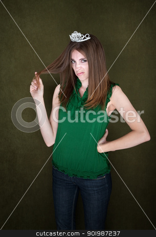 To use this stock image in your creative project, please select the size you need over to the right and click the "Add to Cart" button.
Your downloaded image will come with the Cutcaster watermark removed so don’t worry about the watermark you see on this page. Unimpressed Woman Wearing a Tiara stock photo, Woman with small crown sneers and twirls her hair by Scott Griessel