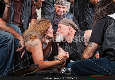 To use this stock image in your creative project, please select the size you need over to the right and click the "Add to Cart" button.
Your downloaded image will come with the Cutcaster watermark removed so don’t worry about the watermark you see on this page. Lovers Kiss While Arm Wrestling stock photo, Two biker gang lovers kiss while arm wrestling by Scott Griessel