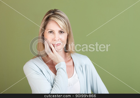 To use this stock image in your creative project, please select the size you need over to the right and click the "Add to Cart" button.
Your downloaded image will come with the Cutcaster watermark removed so don’t worry about the watermark you see on this page. Mature Woman stock photo, Mature Caucasian woman with hand on chin over green background by Scott Griessel