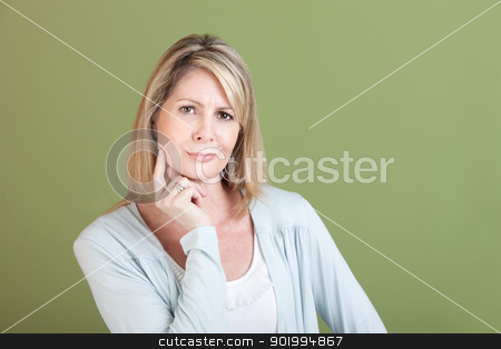 To use this stock image in your creative project, please select the size you need over to the right and click the "Add to Cart" button.
Your downloaded image will come with the Cutcaster watermark removed so don’t worry about the watermark you see on this page. Skeptical Woman stock photo, Skeptical mature woman with finger on chin over green background by Scott Griessel