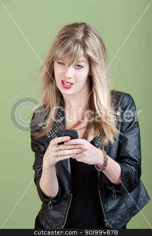 To use this stock image in your creative project, please select the size you need over to the right and click the "Add to Cart" button.
Your downloaded image will come with the Cutcaster watermark removed so don’t worry about the watermark you see on this page. Annoyed Girl On Phone stock photo, Retro-styled young Caucasian lady types text message on her cellphone over green background by Scott Griessel