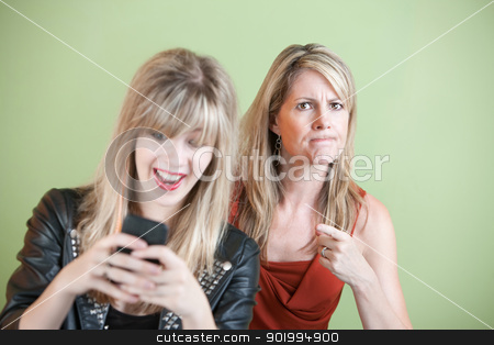 To use this stock image in your creative project, please select the size you need over to the right and click the "Add to Cart" button.
Your downloaded image will come with the Cutcaster watermark removed so don’t worry about the watermark you see on this page. Teen Texting stock photo, Upset woman with laughing teen on cell phone by Scott Griessel