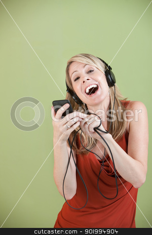 To use this stock image in your creative project, please select the size you need over to the right and click the "Add to Cart" button.
Your downloaded image will come with the Cutcaster watermark removed so don’t worry about the watermark you see on this page. Lady Listens To Music stock photo, Mature Caucasian lady listens to music on headphones over green background by Scott Griessel