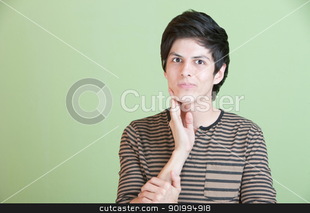To use this stock image in your creative project, please select the size you need over to the right and click the "Add to Cart" button.
Your downloaded image will come with the Cutcaster watermark removed so don’t worry about the watermark you see on this page. Young Man Wonders stock photo, Doubtful young Latino male over green background by Scott Griessel