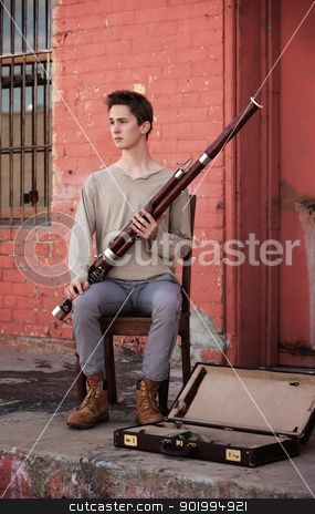 To use this stock image in your creative project, please select the size you need over to the right and click the "Add to Cart" button.
Your downloaded image will come with the Cutcaster watermark removed so don’t worry about the watermark you see on this page. Young Bassoon Musician stock photo, Young Caucasian man with Bassoon sitting on a wooden chair outside by Scott Griessel