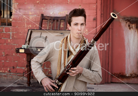 To use this stock image in your creative project, please select the size you need over to the right and click the "Add to Cart" button.
Your downloaded image will come with the Cutcaster watermark removed so don’t worry about the watermark you see on this page. Bassoon Performer stock photo, Handsome young Caucasian man in Indian attire plays a Bassoon by Scott Griessel