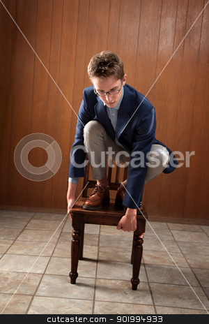 To use this stock image in your creative project, please select the size you need over to the right and click the "Add to Cart" button.
Your downloaded image will come with the Cutcaster watermark removed so don’t worry about the watermark you see on this page. Man Stands On Chair stock photo, Young Caucasian man stands on a chair, looking down by Scott Griessel