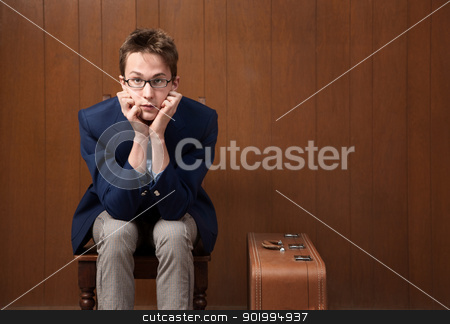 To use this stock image in your creative project, please select the size you need over to the right and click the "Add to Cart" button.
Your downloaded image will come with the Cutcaster watermark removed so don’t worry about the watermark you see on this page. Young Man on Chair with Suitcase stock photo, Serious Caucasian male with chin in hands and suitcase by Scott Griessel