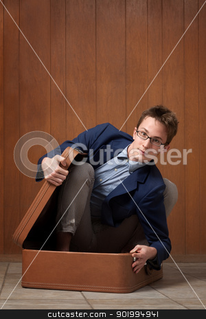 To use this stock image in your creative project, please select the size you need over to the right and click the "Add to Cart" button.
Your downloaded image will come with the Cutcaster watermark removed so don’t worry about the watermark you see on this page. Young Man In Suitcase stock photo, Young Caucasian man stuck in a suitcase by Scott Griessel