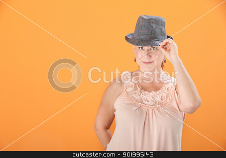 To use this stock image in your creative project, please select the size you need over to the right and click the "Add to Cart" button.
Your downloaded image will come with the Cutcaster watermark removed so don’t worry about the watermark you see on this page. Woman Tips Her Hat stock photo, Middle-aged Caucasian woman on orange background tips her hat by Scott Griessel