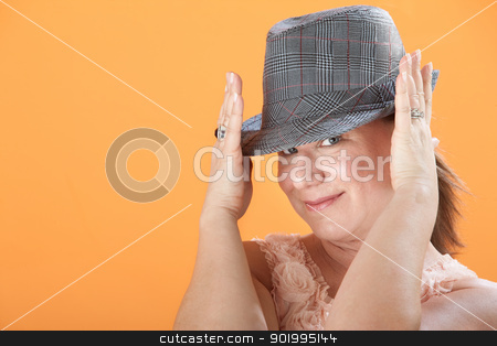 To use this stock image in your creative project, please select the size you need over to the right and click the "Add to Cart" button.
Your downloaded image will come with the Cutcaster watermark removed so don’t worry about the watermark you see on this page. Woman Holds Her Hat stock photo, Caucasian woman on orange background adjusts hat on on her head by Scott Griessel