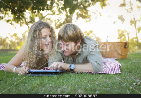 To use this stock image in your creative project, please select the size you need over to the right and click the "Add to Cart" button.
Your downloaded image will come with the Cutcaster watermark removed so don’t worry about the watermark you see on this page. Attractive Loving Couple Using a Touch Pad Outside stock photo, Playful Loving Couple Using a Touch Pad Computer at Their Picnic Outside. by Andy Dean
