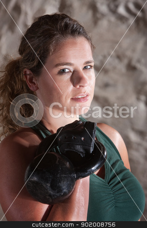 To use this stock image in your creative project, please select the size you need over to the right and click the "Add to Cart" button.
Your downloaded image will come with the Cutcaster watermark removed so don’t worry about the watermark you see on this page. Grinning Woman Holding Kettlebell stock photo, Pretty woman in tank top working out and sweating indoors by Scott Griessel