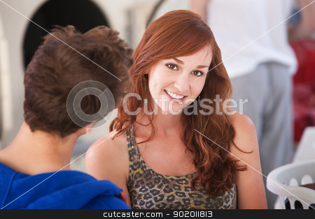 To use this stock image in your creative project, please select the size you need over to the right and click the "Add to Cart" button.
Your downloaded image will come with the Cutcaster watermark removed so don’t worry about the watermark you see on this page. Beautiful Smiling Woman stock photo, Beautiful young Caucasian lady with boyfriend smiles in laundromat by Scott Griessel