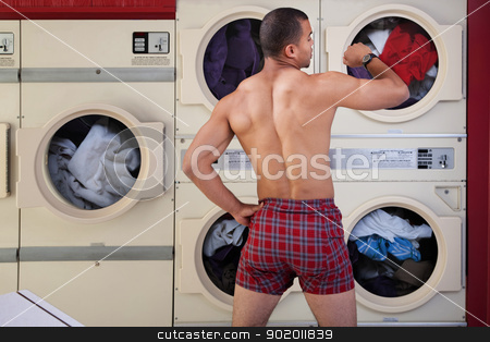 To use this stock image in your creative project, please select the size you need over to the right and click the "Add to Cart" button.
Your downloaded image will come with the Cutcaster watermark removed so don’t worry about the watermark you see on this page. Half-naked Man in Laundromat stock photo, Muscular man in boxer shorts looks at wristwatch in laundromat by Scott Griessel