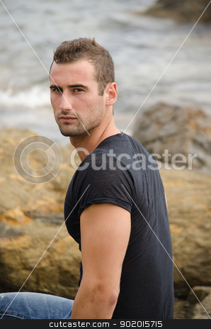 To use this stock image in your creative project, please select the size you need over to the right and click the "Add to Cart" button.
Your downloaded image will come with the Cutcaster watermark removed so don’t worry about the watermark you see on this page. Handsome male model sitting on rock by the sea stock photo, Handsome and fit male model sitting on rock by the sea by Stefano Cavoretto