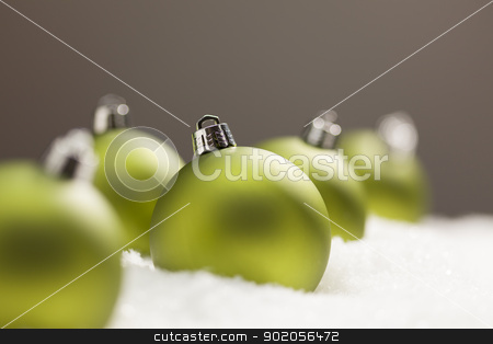 To use this stock image in your creative project, please select the size you need over to the right and click the "Add to Cart" button.
Your downloaded image will come with the Cutcaster watermark removed so don’t worry about the watermark you see on this page. Green Christmas Ornaments on Snow Over a Grey Background stock photo, Green Christmas Ornaments on Snow Flakes Over a Grey Background by Andy Dean