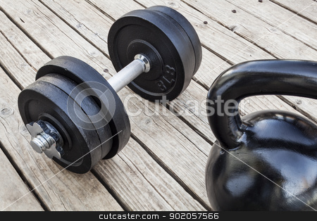To use this stock image in your creative project, please select the size you need over to the right and click the "Add to Cart" button.
Your downloaded image will come with the Cutcaster watermark removed so don’t worry about the watermark you see on this page. kettlebell and dumbbell stock photo, exercise weights - kettlebell and dumbbells on a wooden deck - a home gym concept by Marek Uliasz