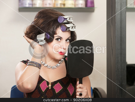To use this stock image in your creative project, please select the size you need over to the right and click the "Add to Cart" button.
Your downloaded image will come with the Cutcaster watermark removed so don’t worry about the watermark you see on this page. Lady Feeling New Hairdo stock photo, Caucasian woman in curlers with mirror feeling her hair by Scott Griessel