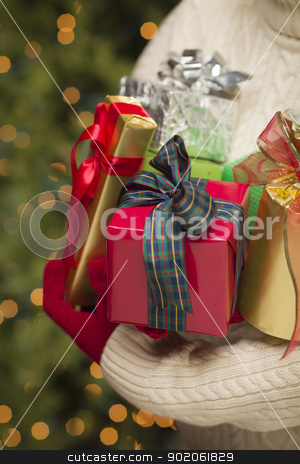 To use this stock image in your creative project, please select the size you need over to the right and click the "Add to Cart" button.
Your downloaded image will come with the Cutcaster watermark removed so don’t worry about the watermark you see on this page. Woman Wearing Seasonal Red Mittens Holding Christmas Gifts stock photo, Woman Wearing A Sweater and Seasonal Red Mittens Against an Abstract Green and Golden Background Holding Beautifully Wrapped Christmas Gifts. by Andy Dean