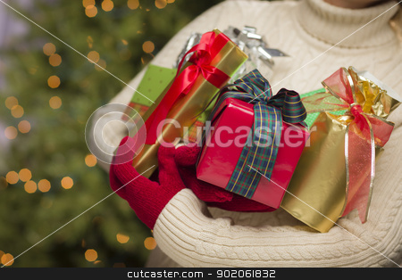 To use this stock image in your creative project, please select the size you need over to the right and click the "Add to Cart" button.
Your downloaded image will come with the Cutcaster watermark removed so don’t worry about the watermark you see on this page. Woman Wearing Seasonal Red Mittens Holding Christmas Gifts stock photo, Woman Wearing A Sweater and Seasonal Red Mittens Against an Abstract Green and Golden Background Holding Beautifully Wrapped Christmas Gifts. by Andy Dean