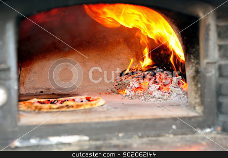 To use this stock image in your creative project, please select the size you need over to the right and click the "Add to Cart" button.
Your downloaded image will come with the Cutcaster watermark removed so don’t worry about the watermark you see on this page. Wood Fired Pizza Oven stock photo, Baking Pizzas in a wood burning pizza oven with glowing coals and embers with flames shooting up by Lynn Bendickson