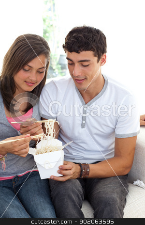 To use this stock image in your creative project, please select the size you need over to the right and click the "Add to Cart" button.
Your downloaded image will come with the Cutcaster watermark removed so don’t worry about the watermark you see on this page. Couple of teenagers eating pasta stock photo, Couple of teenagers eating pasta at home on the sofa by Wavebreak Media