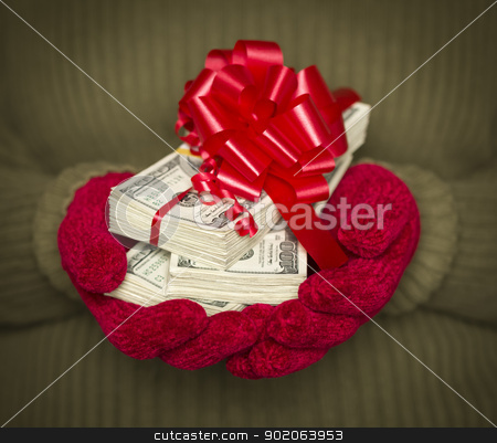 To use this stock image in your creative project, please select the size you need over to the right and click the "Add to Cart" button.
Your downloaded image will come with the Cutcaster watermark removed so don’t worry about the watermark you see on this page. Woman Wearing Mittens Holding Stacks of Money with Red Ribbon stock photo, Woman Wearing Red Mittens and Green Sweater Holding Stacks of Hundreds of Dollars of Money with Red Ribbon. by Andy Dean