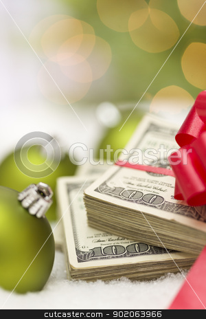 To use this stock image in your creative project, please select the size you need over to the right and click the "Add to Cart" button.
Your downloaded image will come with the Cutcaster watermark removed so don’t worry about the watermark you see on this page. Stack of Hundred Dollar Bills with Bow Near Christmas Ornaments stock photo, Stack of One Hundred Dollar Bills with Red Bow Near Green Christmas Ornaments on Snow Flakes. by Andy Dean