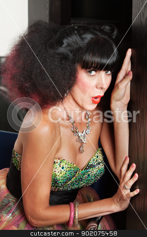 To use this stock image in your creative project, please select the size you need over to the right and click the "Add to Cart" button.
Your downloaded image will come with the Cutcaster watermark removed so don’t worry about the watermark you see on this page. Woman in Afro Wig Hiding stock photo, Pretty European woman with frizzy haircut escaping room by Scott Griessel